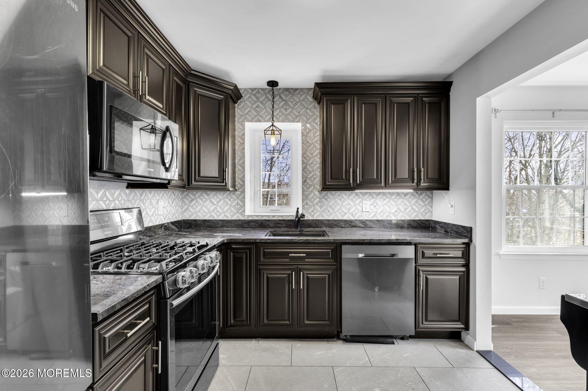 231 Atlantic Street, Unit 55 Keyport, NJ 07735 - Photo 4 of 31 a kitchen with stainless steel appliances granite countertop a stove and a microwave