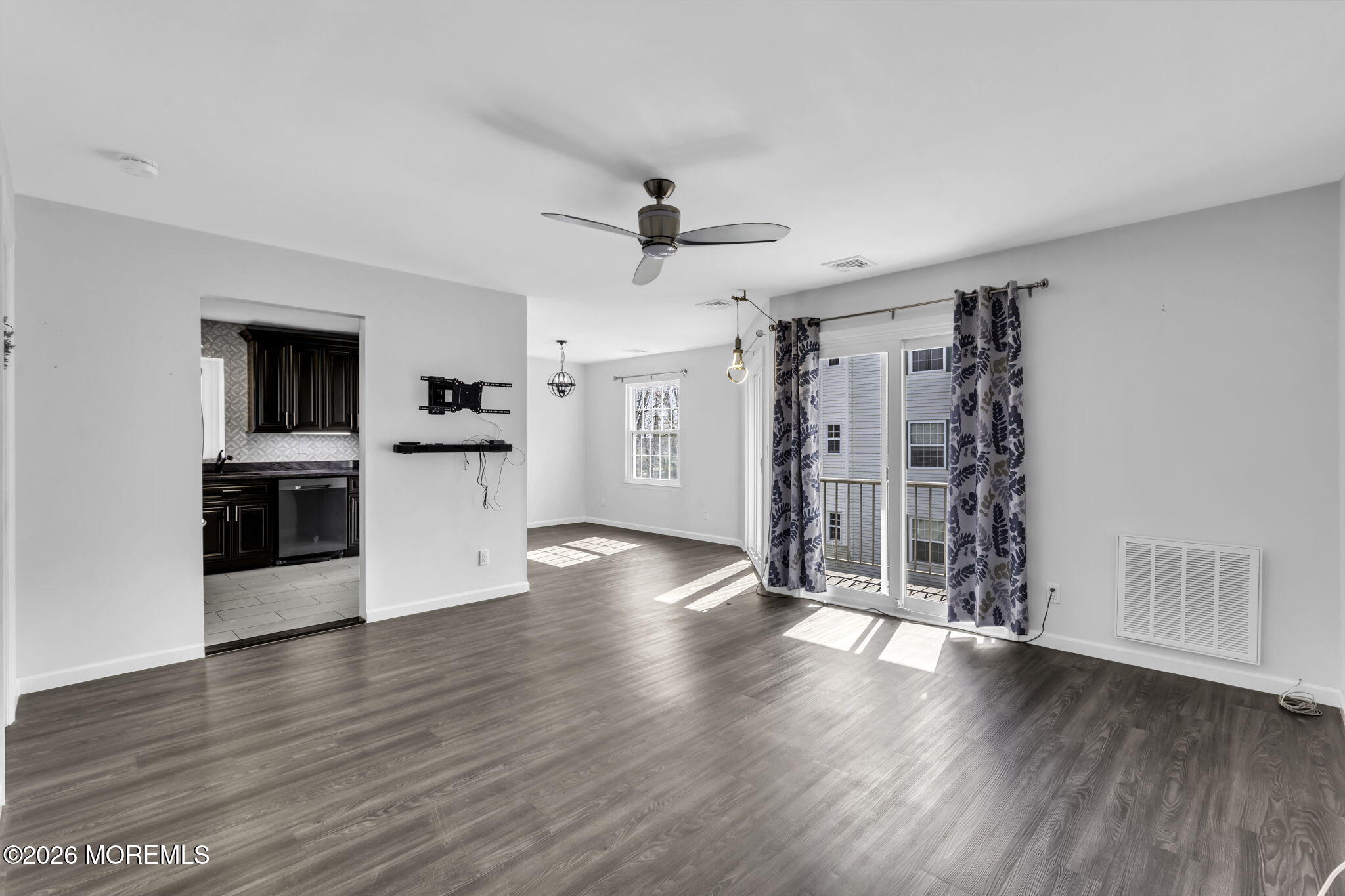 231 Atlantic Street, Unit 55 Keyport, NJ 07735 - Photo 6 of 31 a view of a kitchen with a microwave and wooden floor