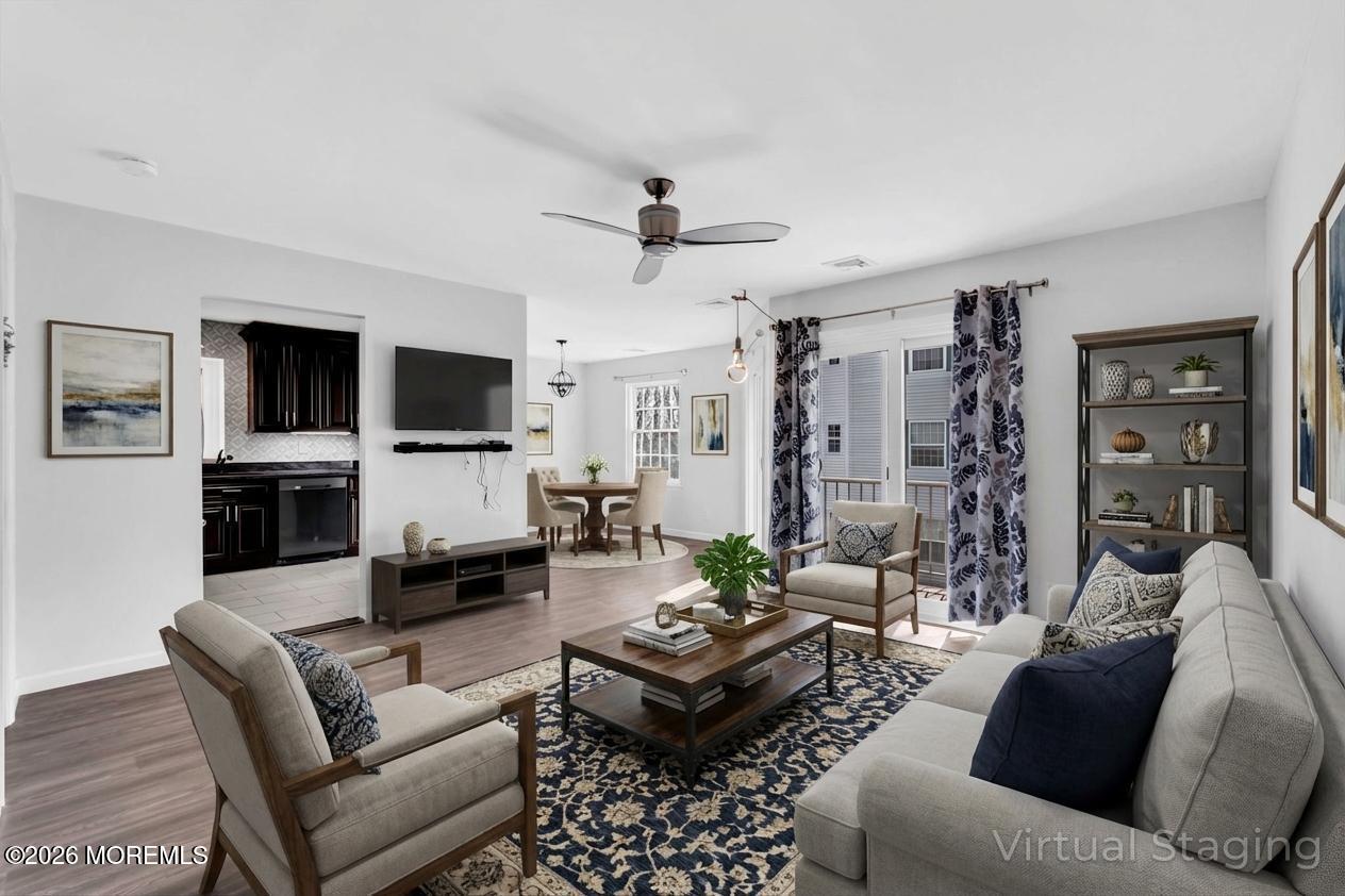 231 Atlantic Street, Unit 55 Keyport, NJ 07735 - Photo 7 of 31 a living room with furniture a flat screen tv and kitchen view