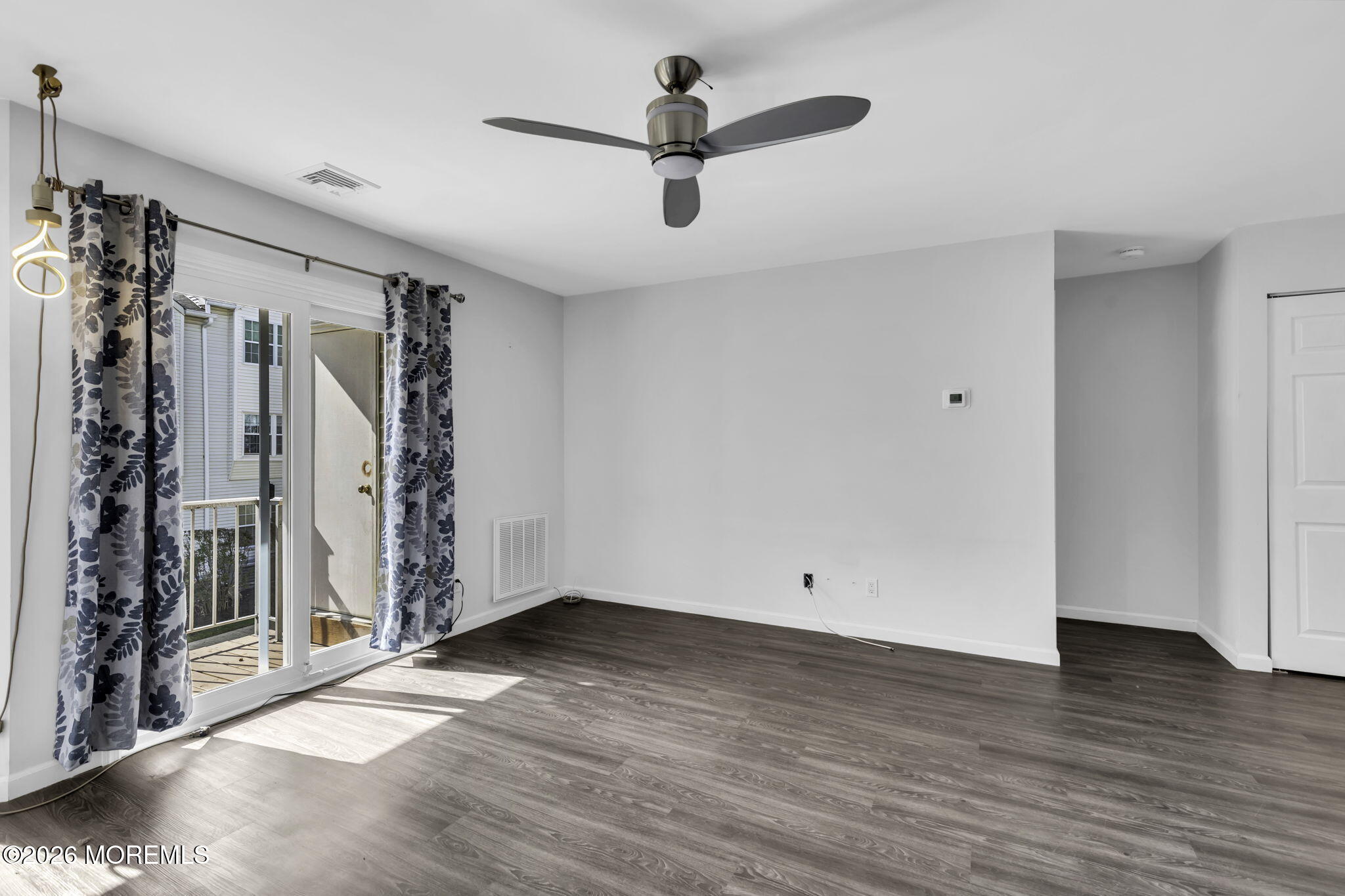 231 Atlantic Street, Unit 55 Keyport, NJ 07735 - Photo 8 of 31 a view of empty room with wooden floor and ceiling fan