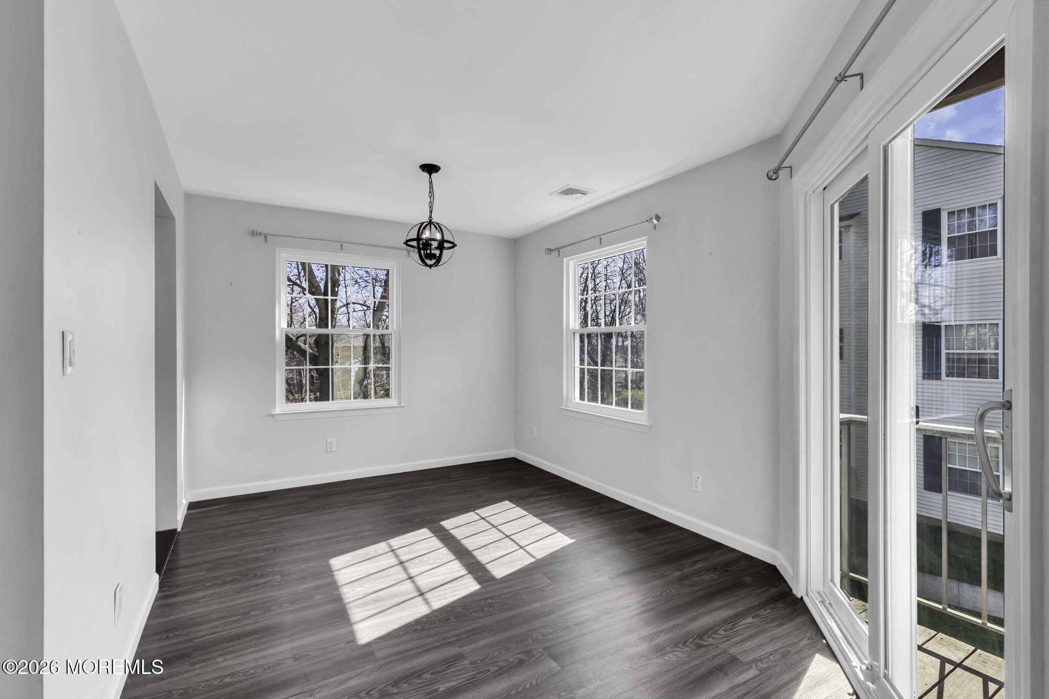231 Atlantic Street, Unit 55 Keyport, NJ 07735 - Photo 9 of 31 a view of empty room with wooden floor and fan