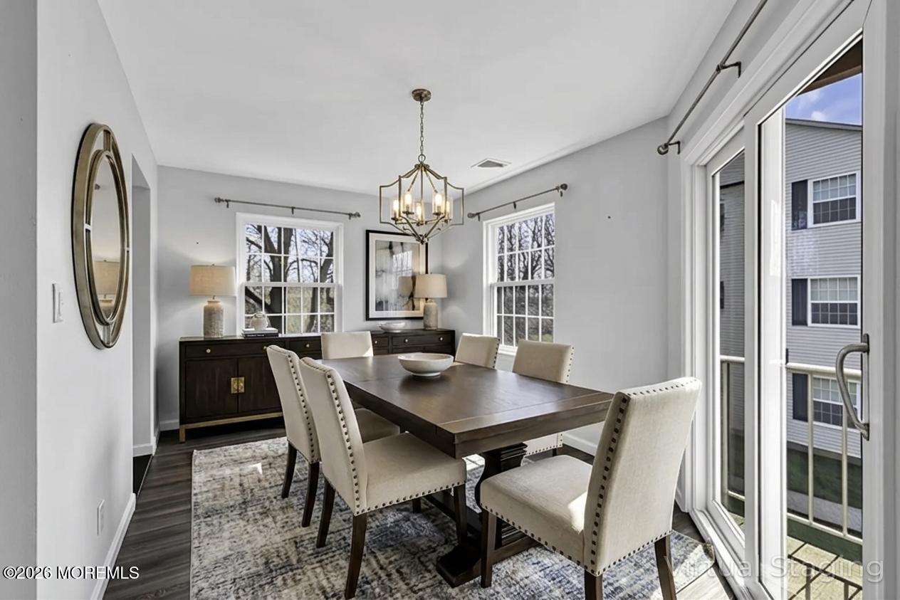 231 Atlantic Street, Unit 55 Keyport, NJ 07735 - Photo 10 of 31 a view of a dining room with furniture window and wooden floor