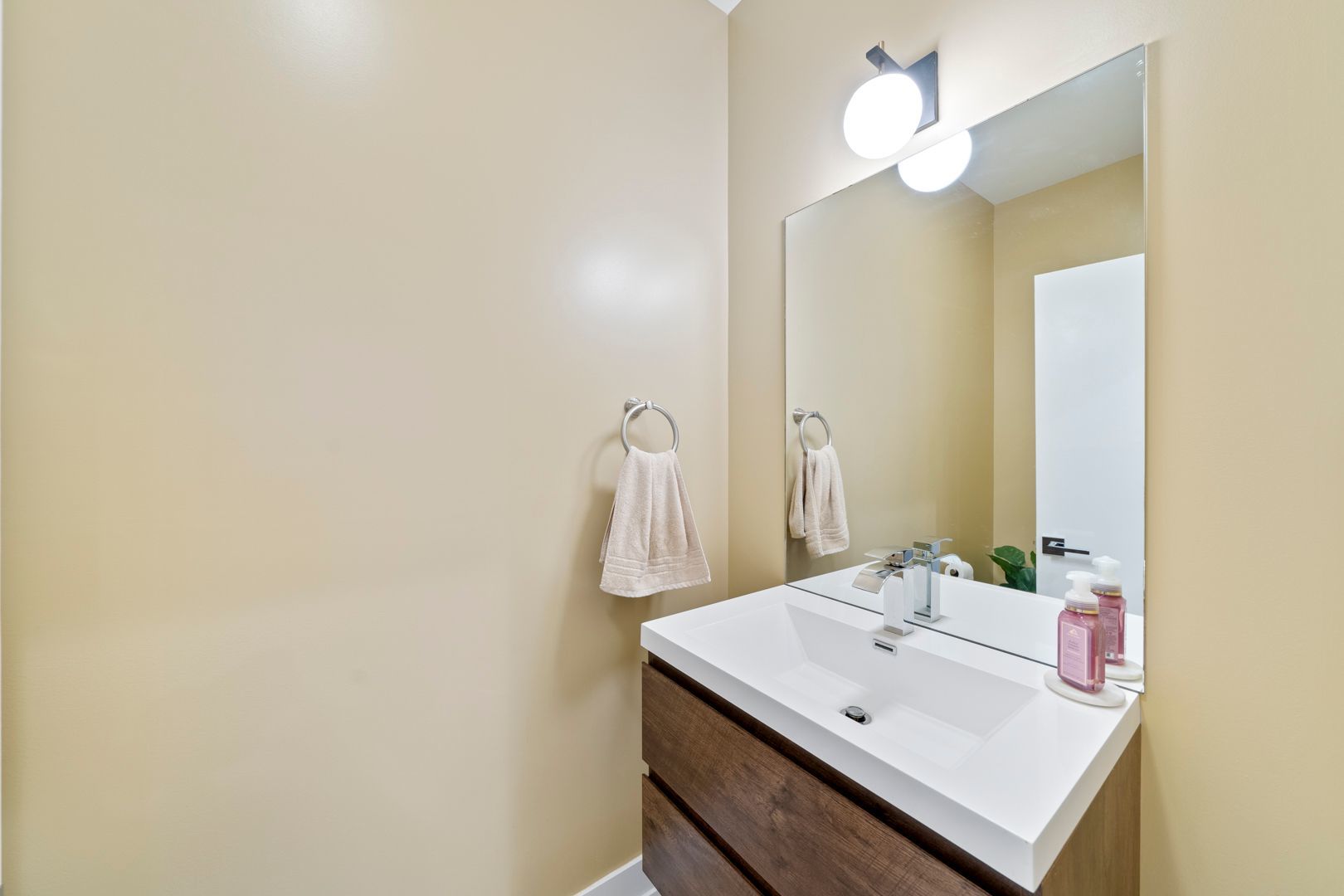 2304 West Jackson Boulevard, Unit 1E Chicago, IL 60612 - Photo 7 of 20 a bathroom with a sink a mirror and a light fixture