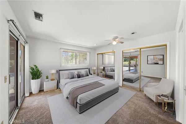 a bedroom with a large bed and a chandelier