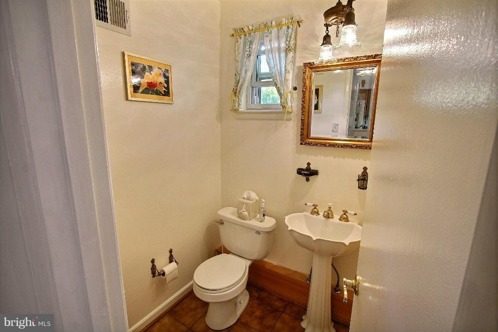 12902 Goodhill Road Silver Spring, MD 20906 - Photo 16 of 20 a bathroom with a toilet sink and mirror
