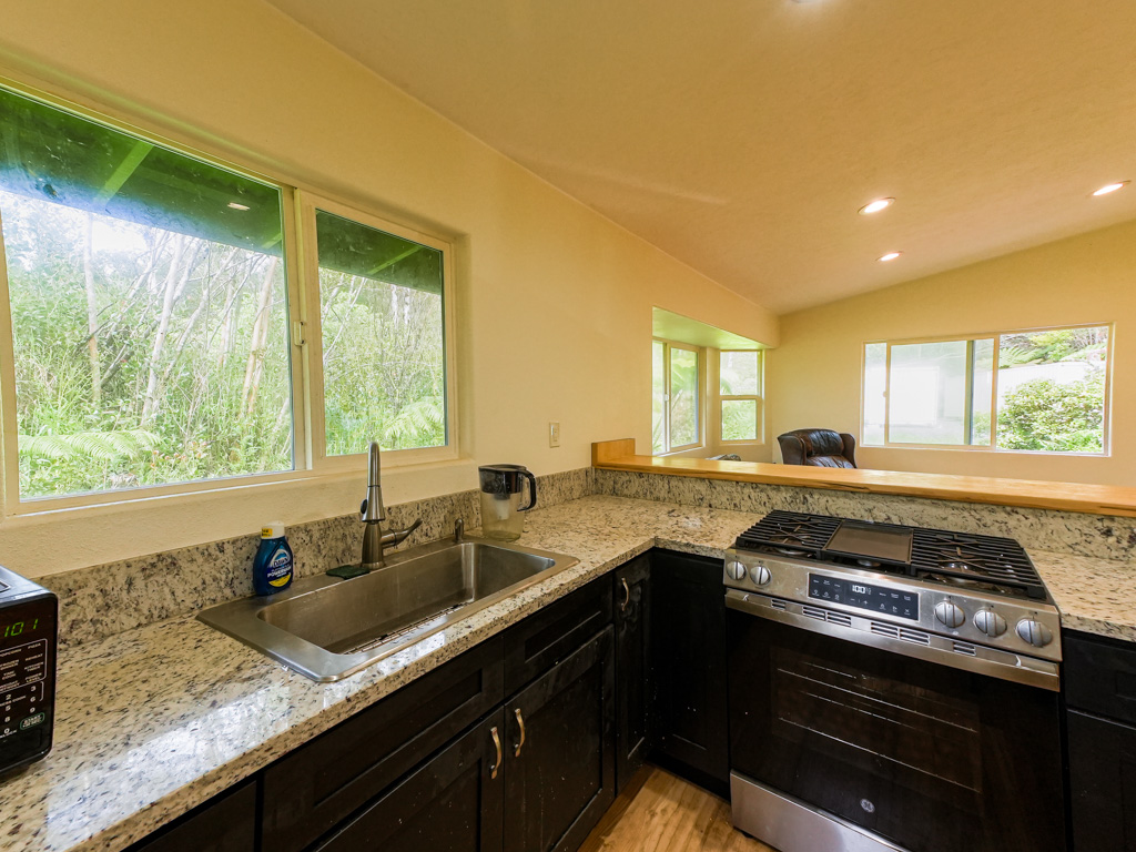1 9th Street Mountain View, HI 96771 - Photo 7 of 21 a kitchen with a sink stove and cabinets
