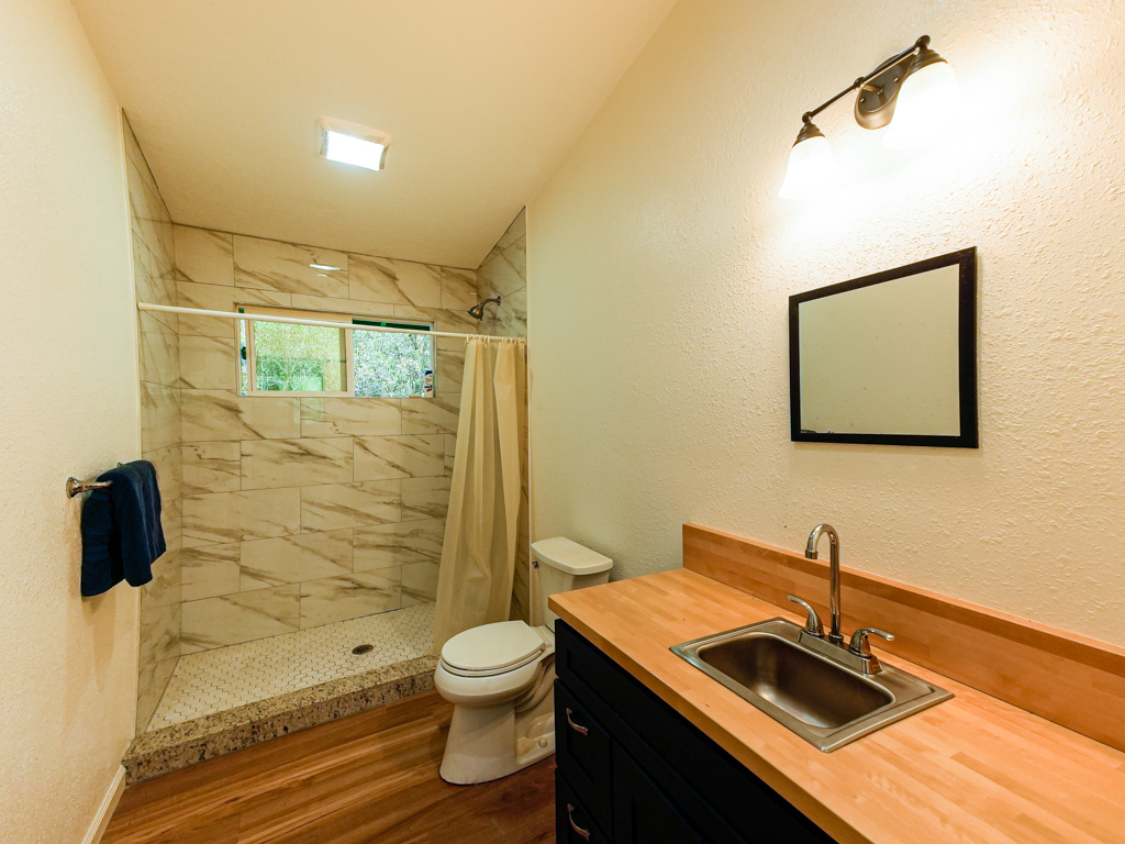 1 9th Street Mountain View, HI 96771 - Photo 9 of 21 a bathroom with a sink a toilet and shower