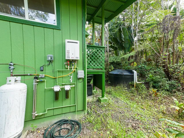 a green field with some trees in the background