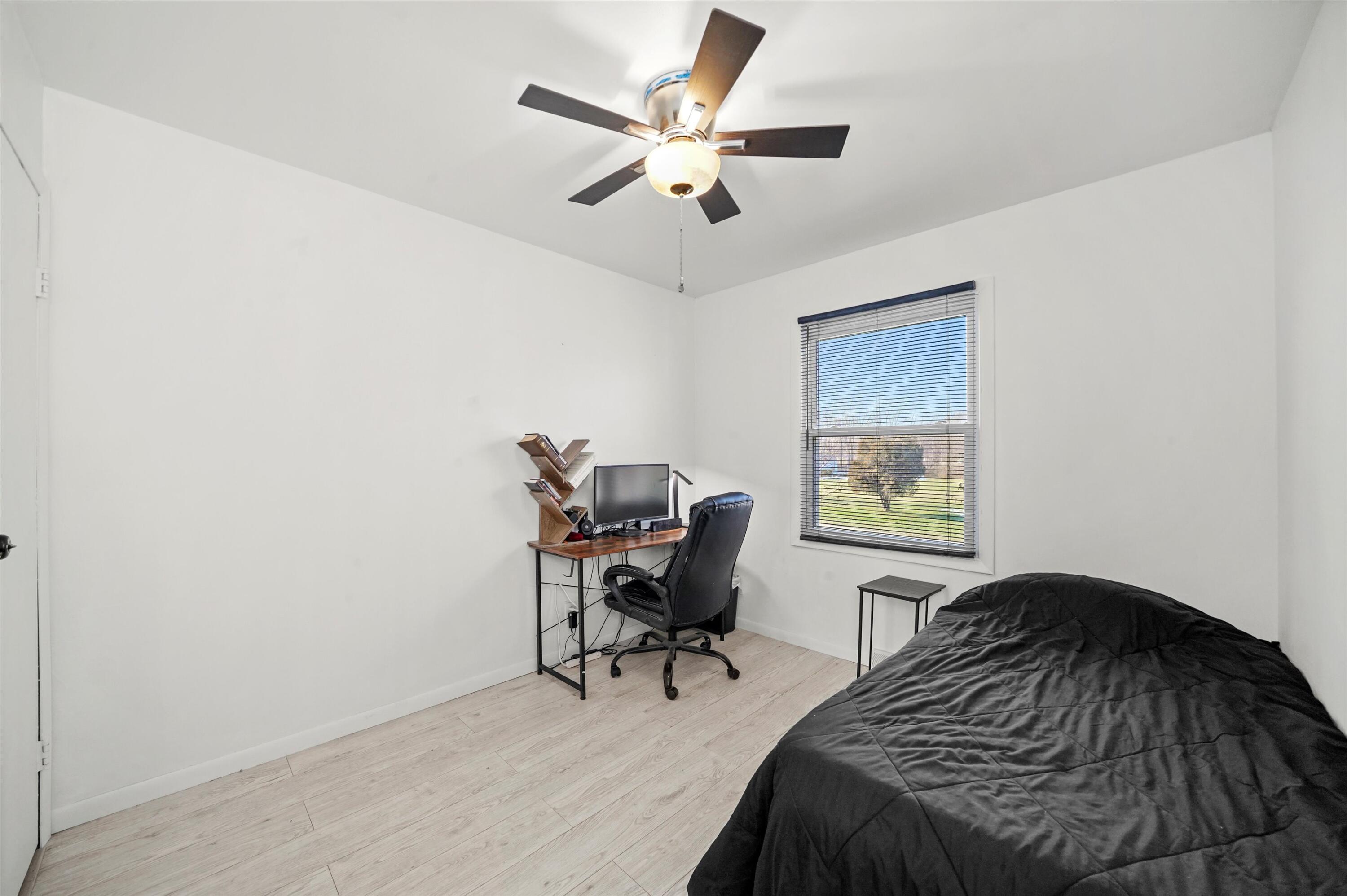 7315 Taney Place Merrillville, IN 46410 - Photo 11 of 26 a bedroom with a bed and a chair