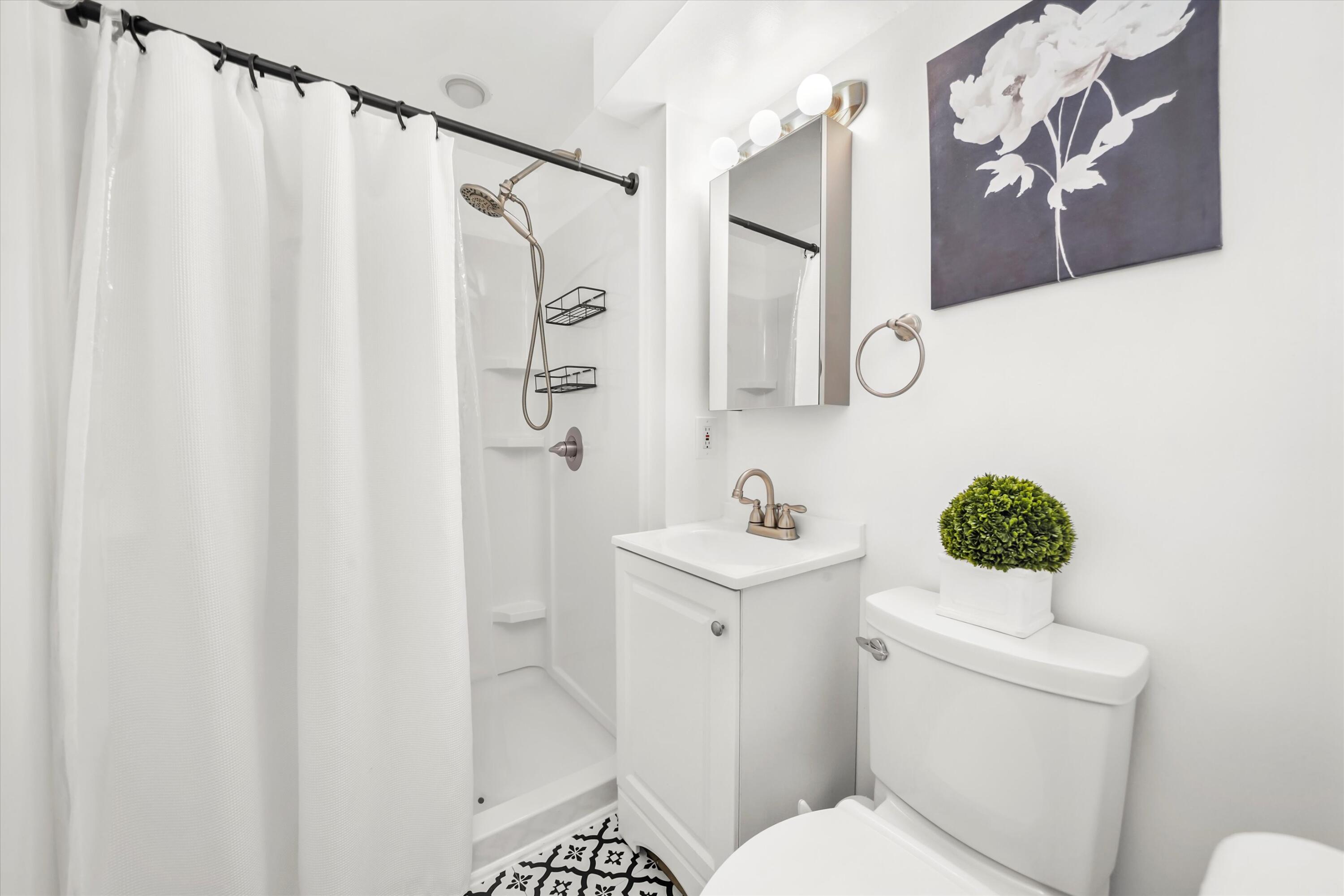 7315 Taney Place Merrillville, IN 46410 - Photo 15 of 26 a bathroom with a sink a toilet and shower