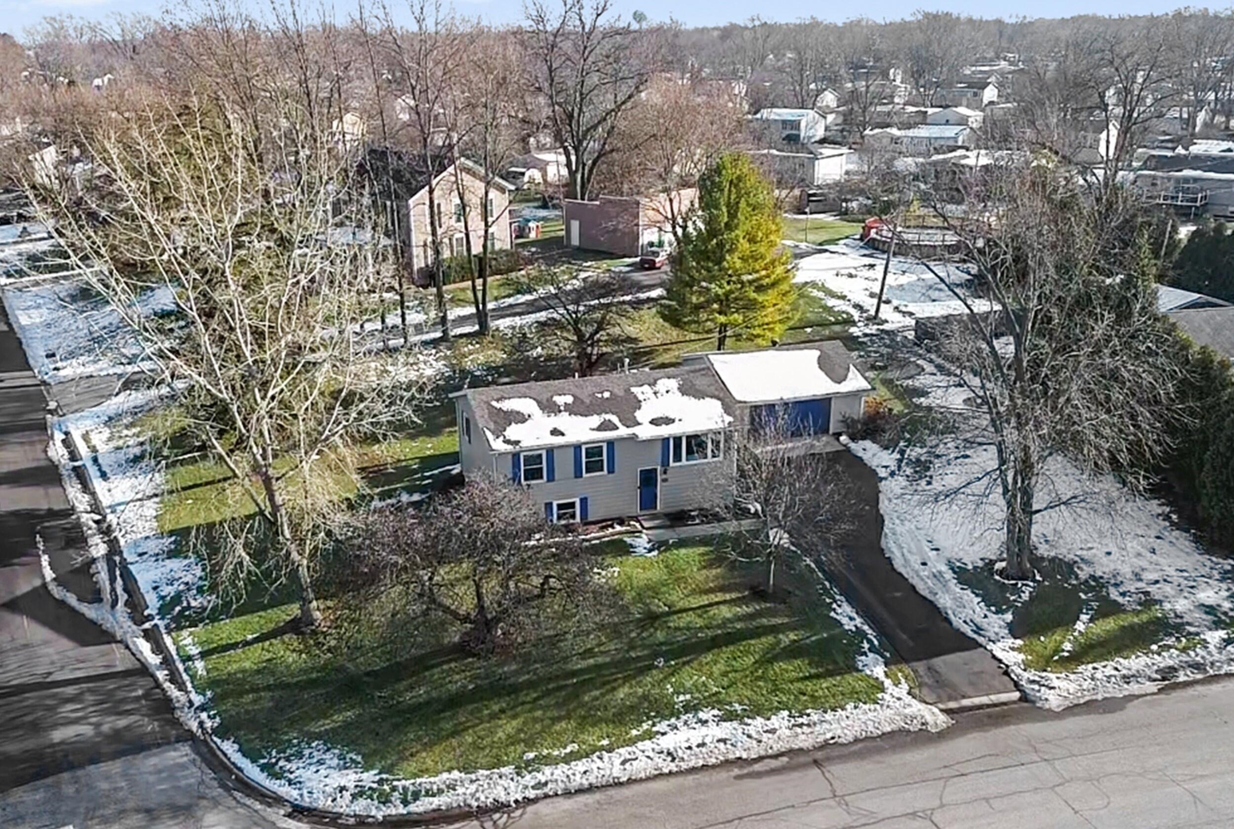 7315 Taney Place Merrillville, IN 46410 - Photo 2 of 26 a aerial view of a house with a yard and large trees