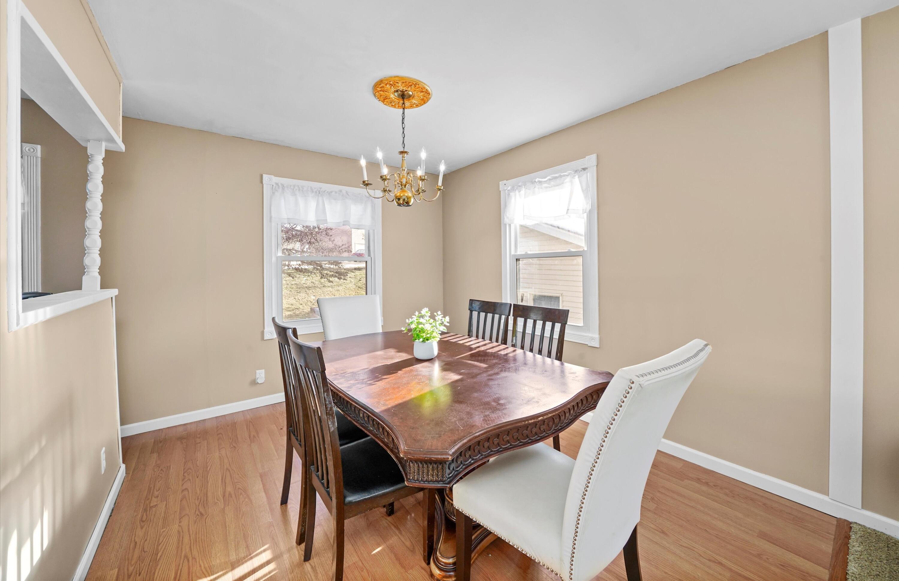 7315 Taney Place Merrillville, IN 46410 - Photo 5 of 26 a view of a dining room with furniture wooden floor and chandelier
