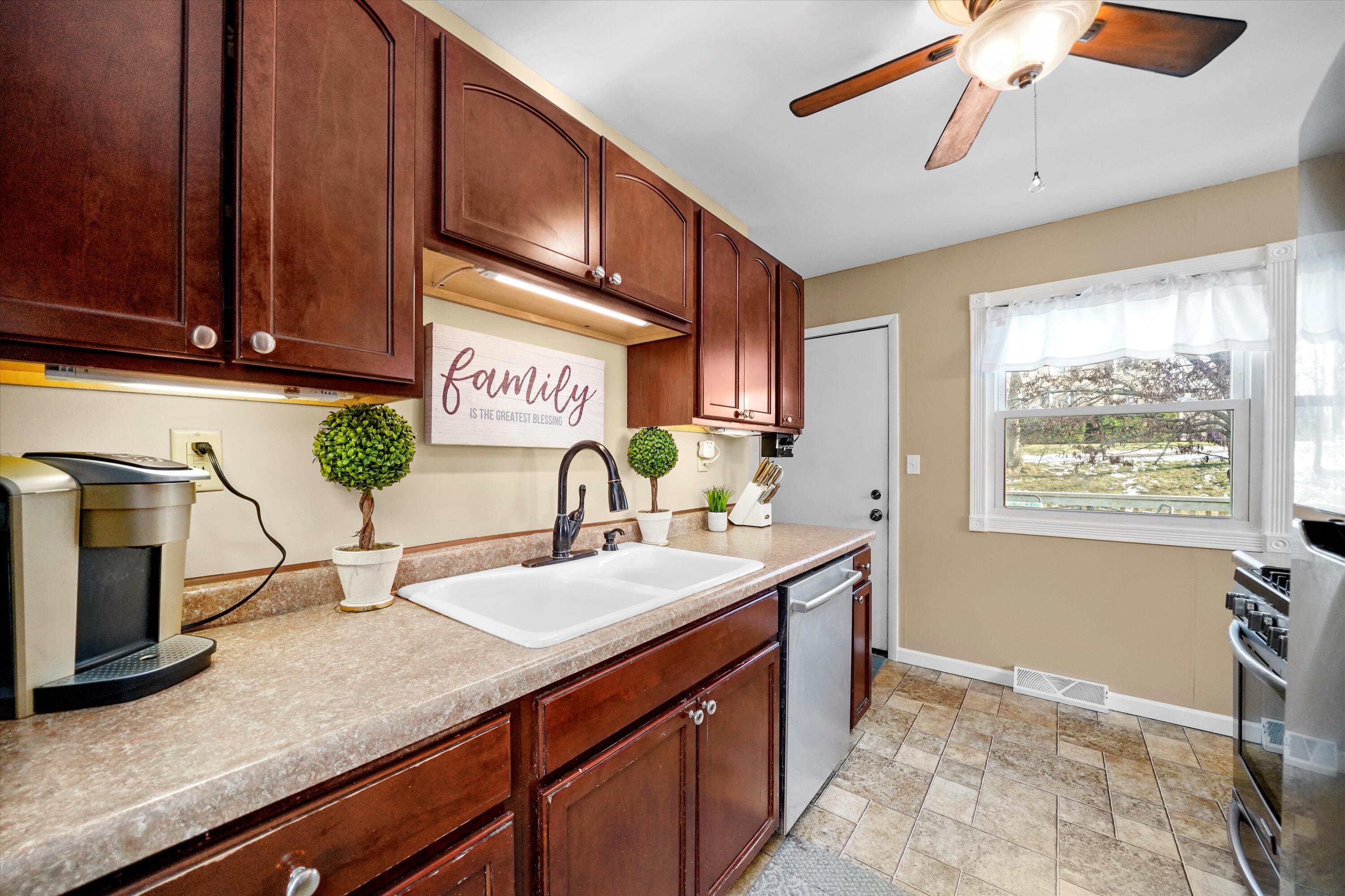 7315 Taney Place Merrillville, IN 46410 - Photo 6 of 26 a kitchen with granite countertop a sink a stove and cabinets