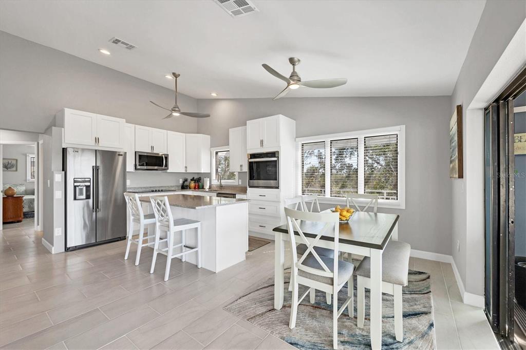 331 Bocilla Drive Boca Grande, FL 33921 - Photo 17 of 34 a dining room with stainless steel appliances kitchen island granite countertop a dining table chairs and granite counter tops