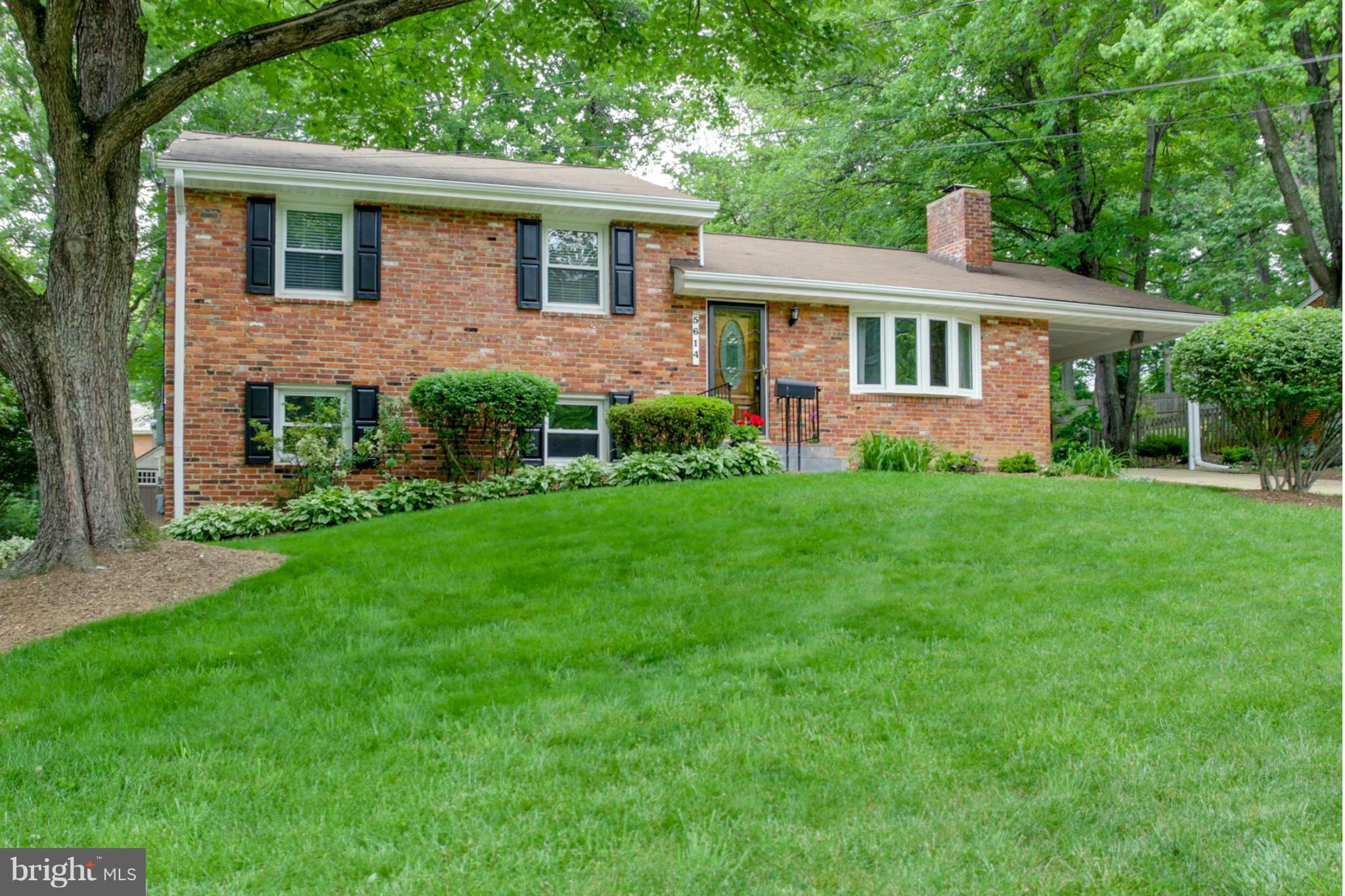 5614 Heming Avenue Springfield, VA 22151 - Photo 1 of 30 a front view of a house with a garden and yard
