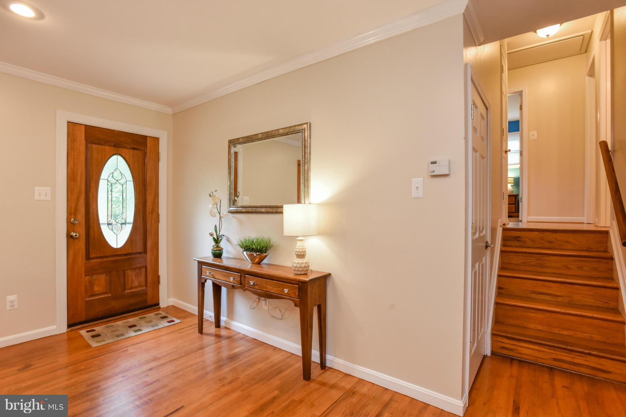 5614 Heming Avenue Springfield, VA 22151 - Photo 2 of 30 a living room with furniture a mirror and wooden floor