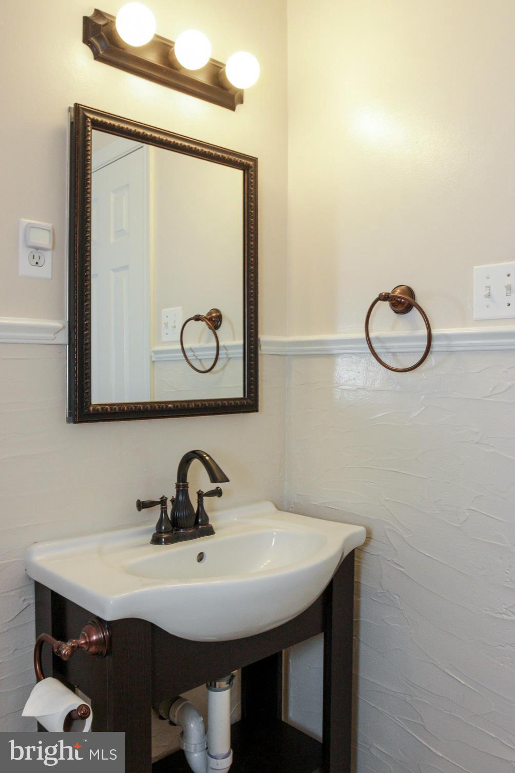 5614 Heming Avenue Springfield, VA 22151 - Photo 15 of 30 a bathroom with a sink and a mirror