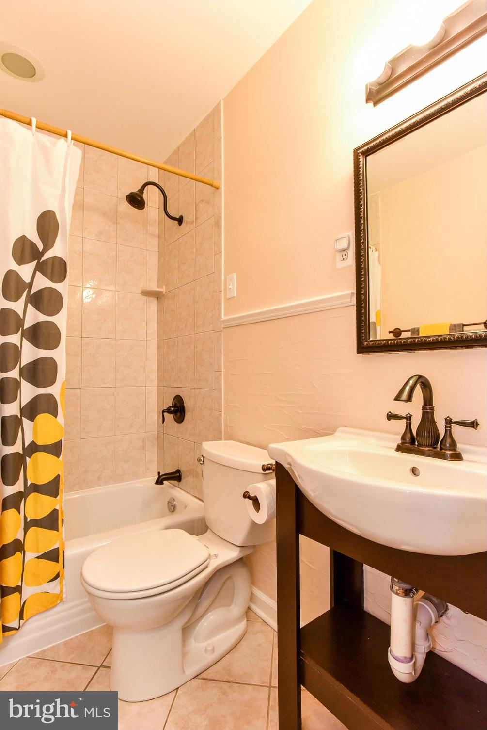 5614 Heming Avenue Springfield, VA 22151 - Photo 16 of 30 a bathroom with a sink a toilet and a mirror