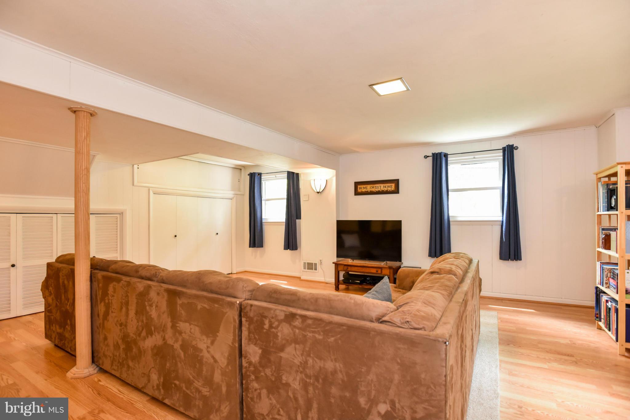 5614 Heming Avenue Springfield, VA 22151 - Photo 18 of 30 a living room with furniture tv and a fireplace