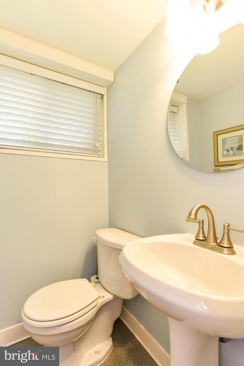 5614 Heming Avenue Springfield, VA 22151 - Photo 20 of 30 a white toilet sitting next to a bathroom sink