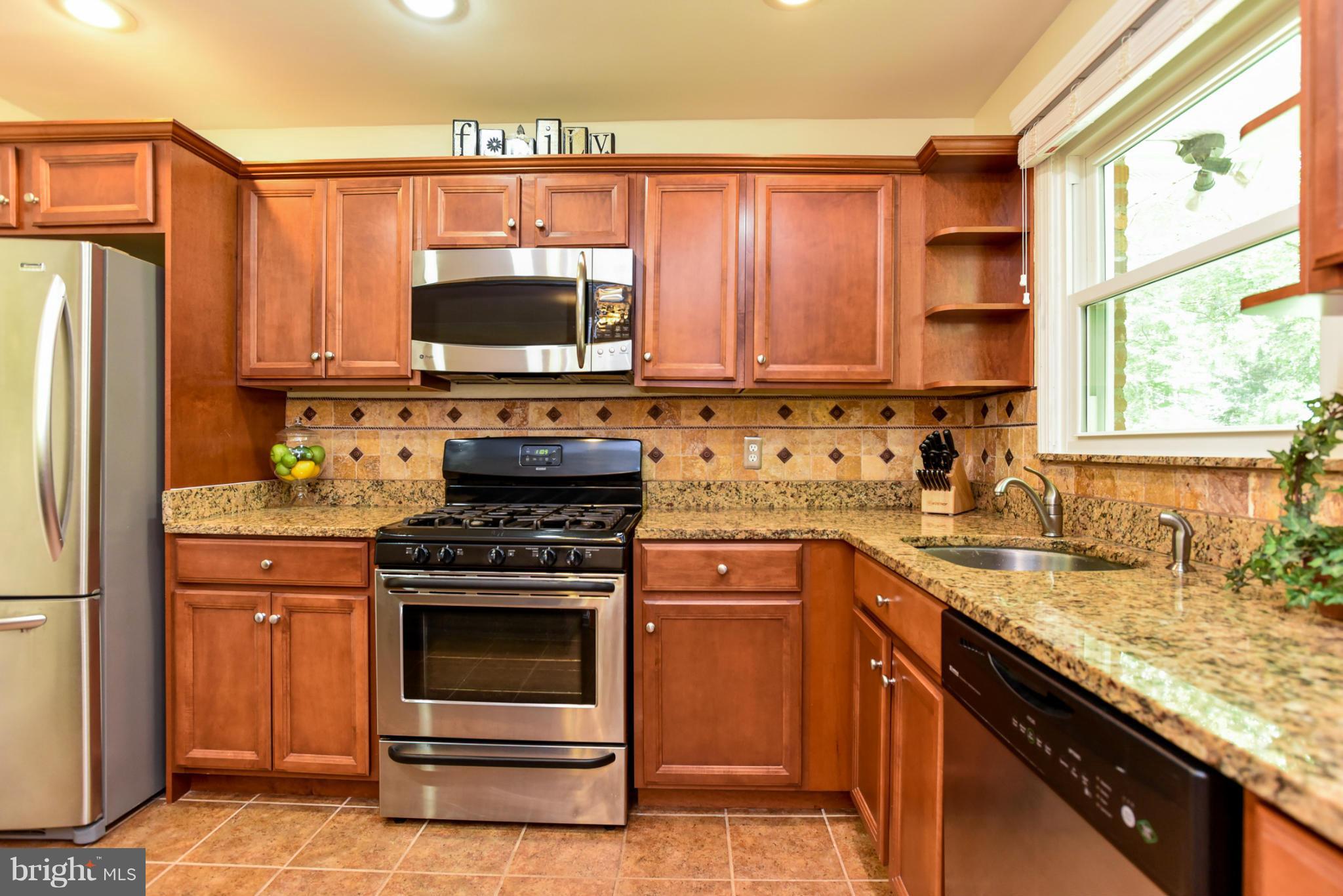 5614 Heming Avenue Springfield, VA 22151 - Photo 7 of 30 a kitchen with a stove a sink and a microwave