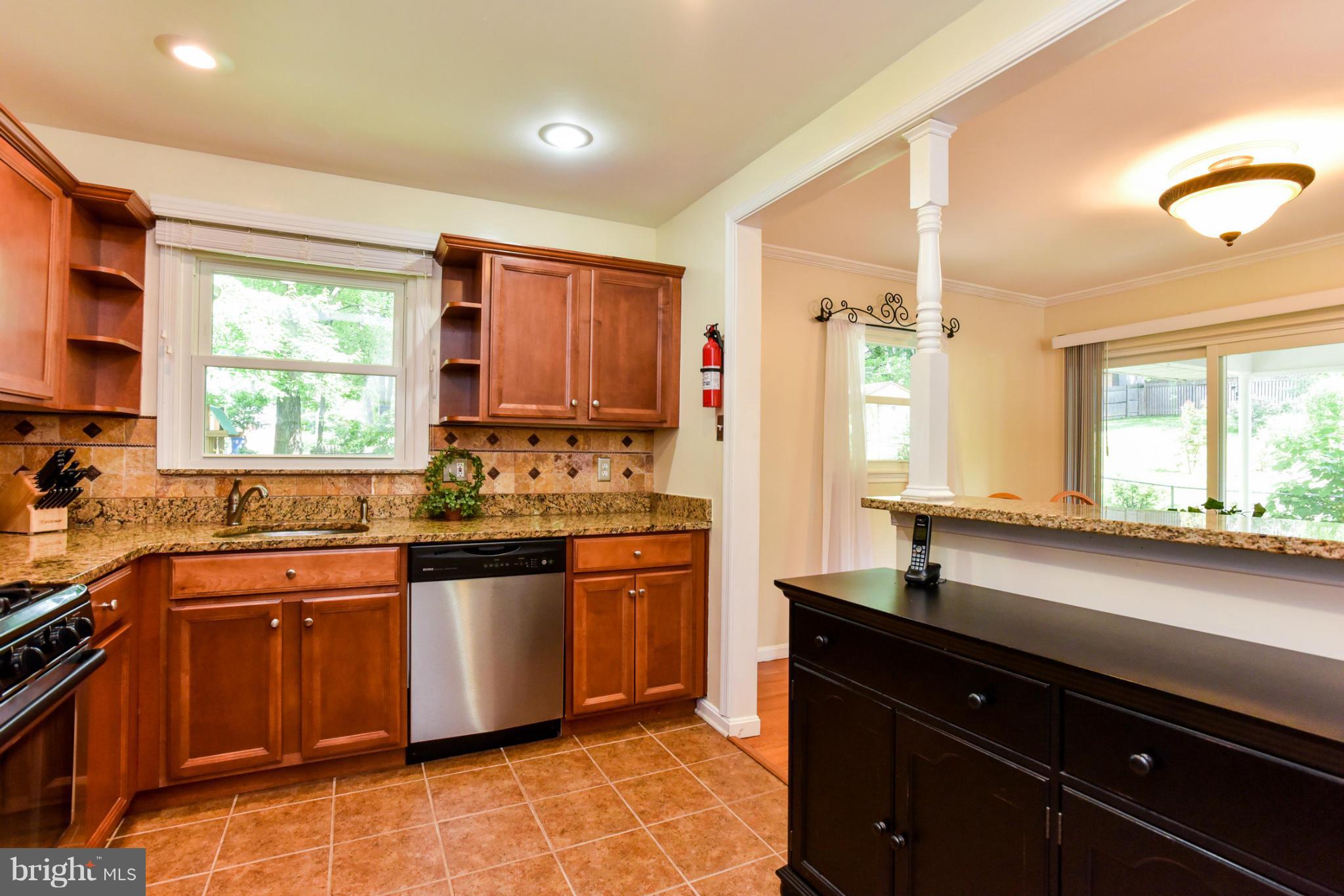 5614 Heming Avenue Springfield, VA 22151 - Photo 8 of 30 a kitchen with stainless steel appliances granite countertop sink stove and cabinets