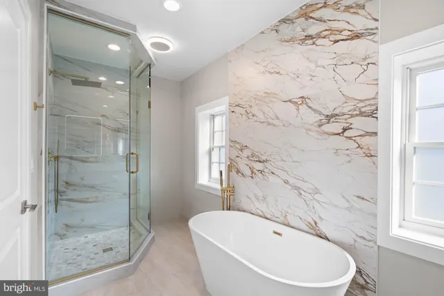 a bathroom with a sink a tub and a mirror