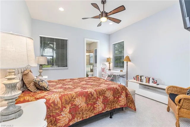 a bedroom with a bed gym equipment and a large window