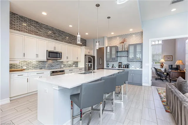 a kitchen with counter top space a sink appliances and cabinets