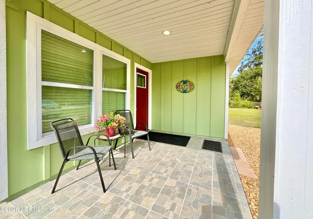 a living room with furniture potted plant and a window