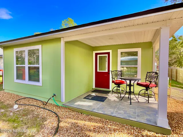 a very nice looking dining room with kitchen island wooden floor and a view of living room