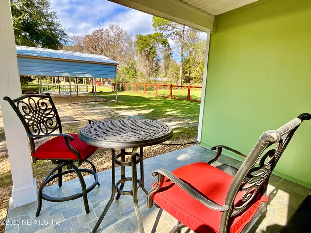 a large white kitchen with a stove a sink dishwasher and a refrigerator with wooden floor