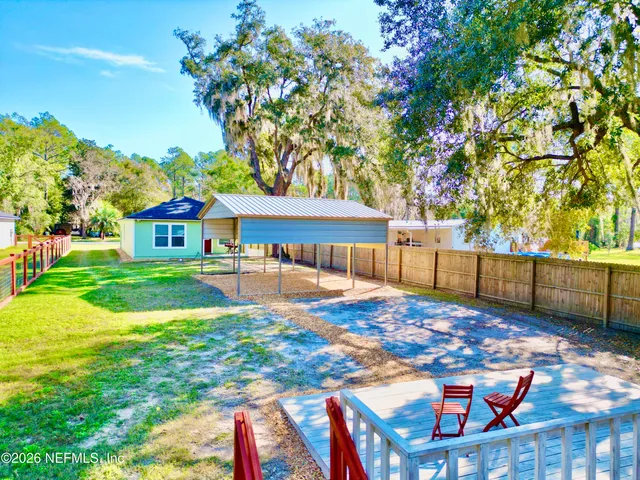 a bedroom with a bed and a flat tv screen on the dresser