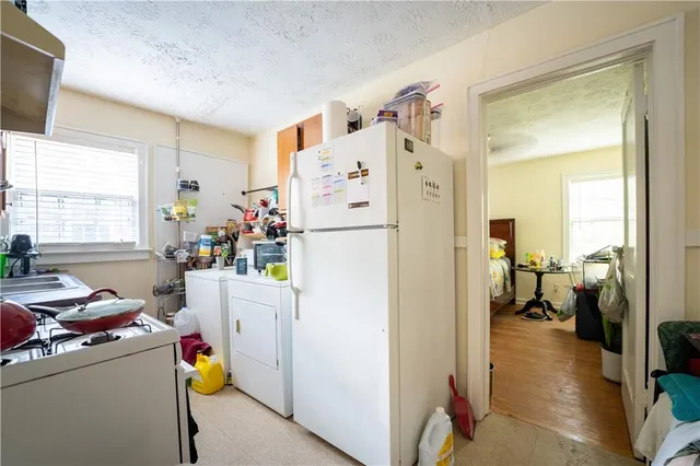 a white refrigerator freezer sitting inside of a kitchen
