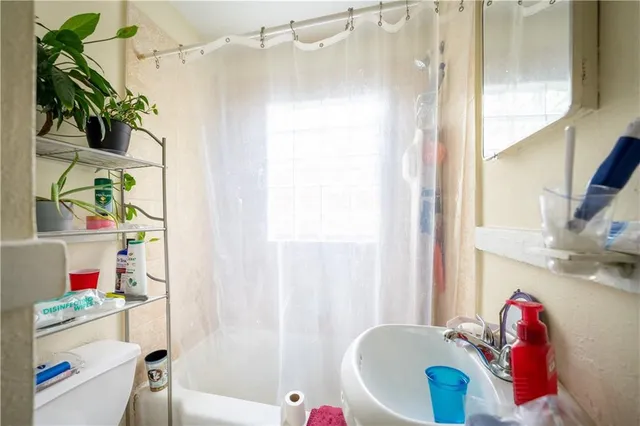 a bathroom with a sink mirror toilet and bathtub