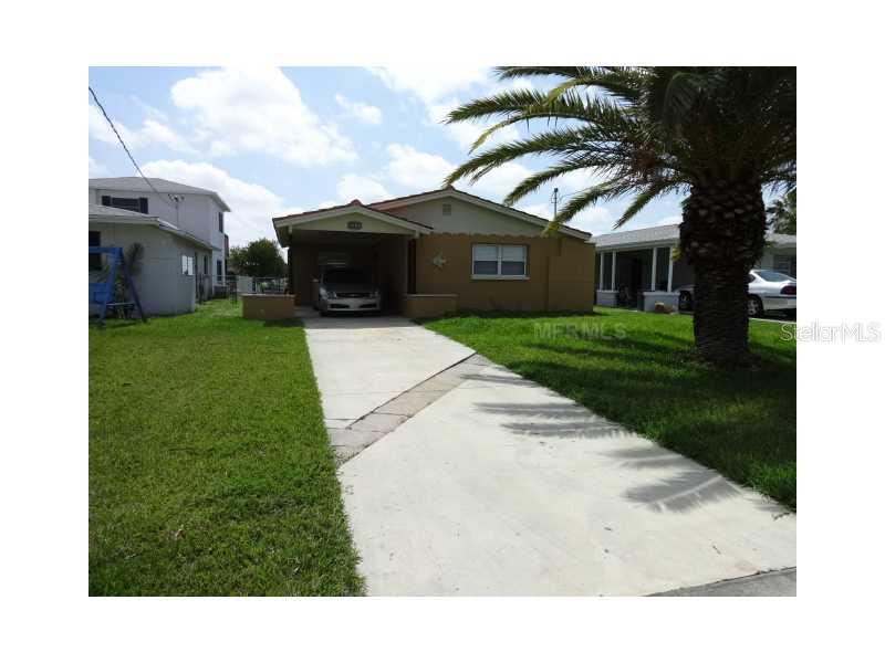 4452 Floramar Terrace New Port Richey, FL 34652 - Photo 1 of 1 a front view of a house with a garden