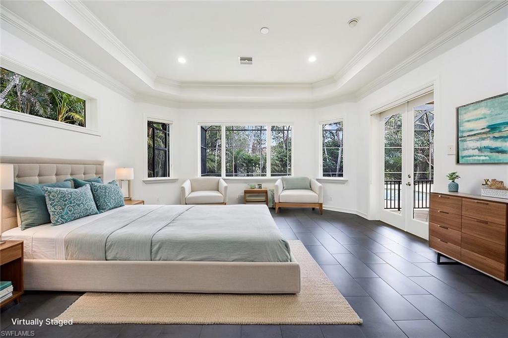 3110 Crayton Road Naples, FL 34103 - Photo 14 of 38 Virtually Staged - Large primary bedroom with tile floors, windows/sliders for natural light and access to the pool/spa/lanai.