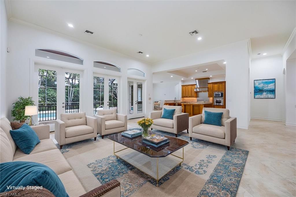 3110 Crayton Road Naples, FL 34103 - Photo 2 of 38 Virtually Staged - Great room with access to the kitchen and the pool/spa/lanai thru french doors.