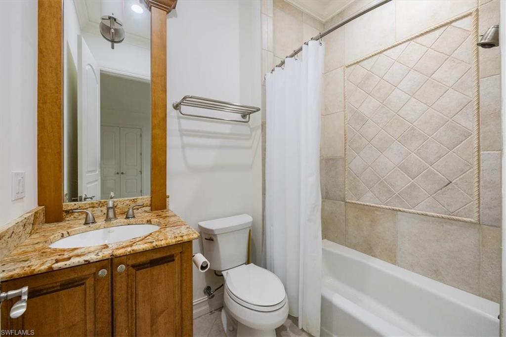 3110 Crayton Road Naples, FL 34103 - Photo 21 of 38 Guest bathroom with granite counter, toilet and shower/tub combo.