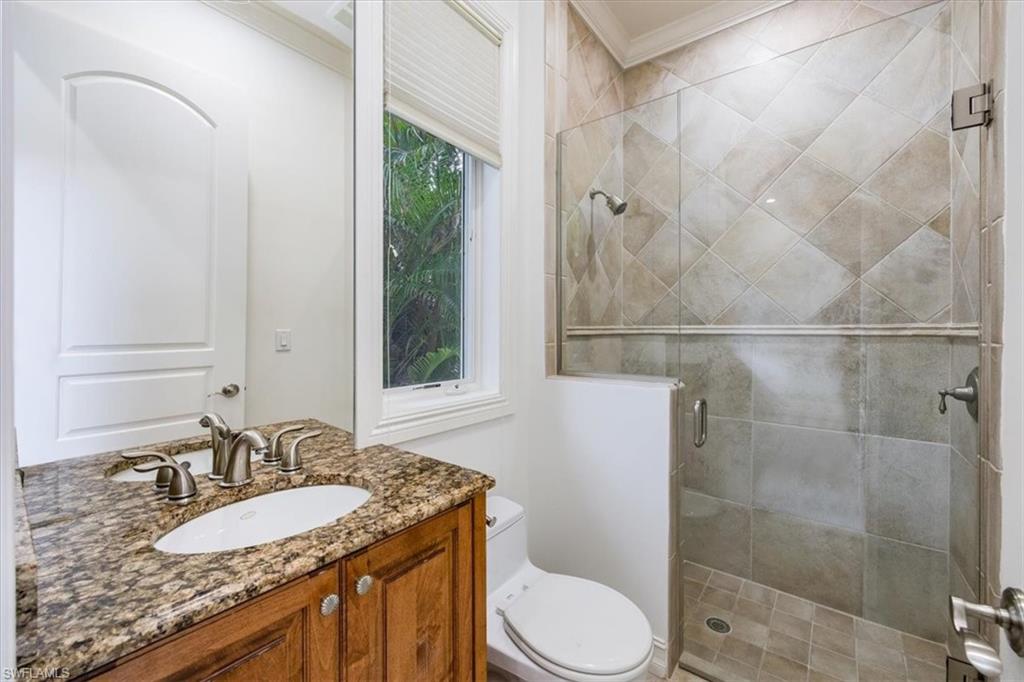 3110 Crayton Road Naples, FL 34103 - Photo 27 of 38 Guest bathroom with granite countertop, toilet and shower.