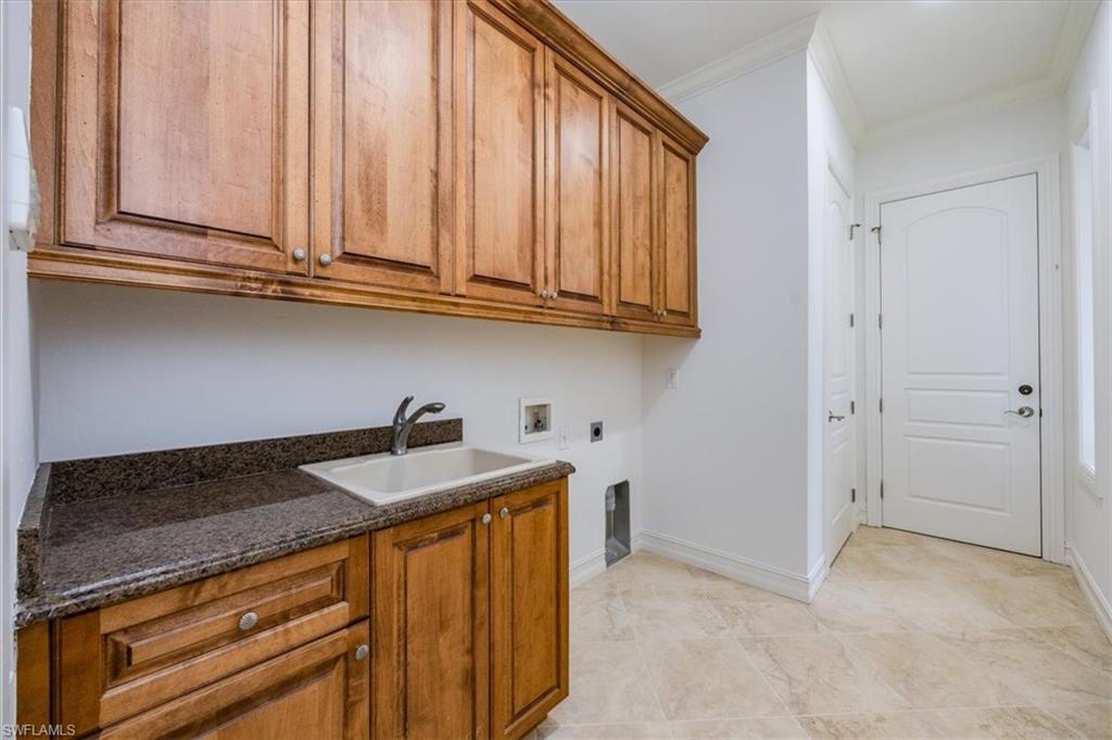 3110 Crayton Road Naples, FL 34103 - Photo 28 of 38 Laundry Room with built in wood cabinetry.