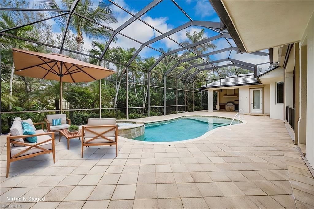 3110 Crayton Road Naples, FL 34103 - Photo 31 of 38 Virtually Staged - Enclosed lanai with pool, spa, covered area (to the far right) and outdoor kitchen.