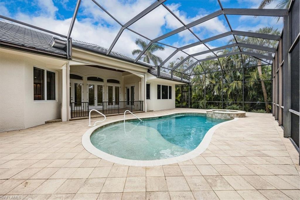 3110 Crayton Road Naples, FL 34103 - Photo 33 of 38 Enclosed lanai with pool, spa, covered area and outdoor kitchen (not shown).