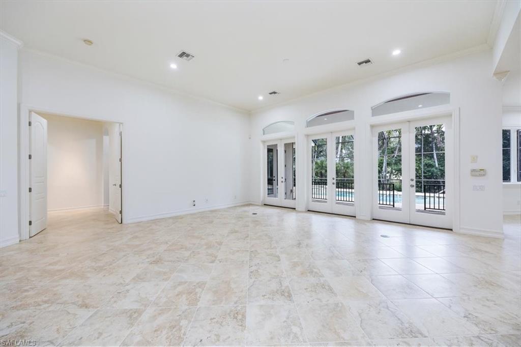 3110 Crayton Road Naples, FL 34103 - Photo 5 of 38 Great room with access to the kitchen and the pool/spa/lanai thru french doors.