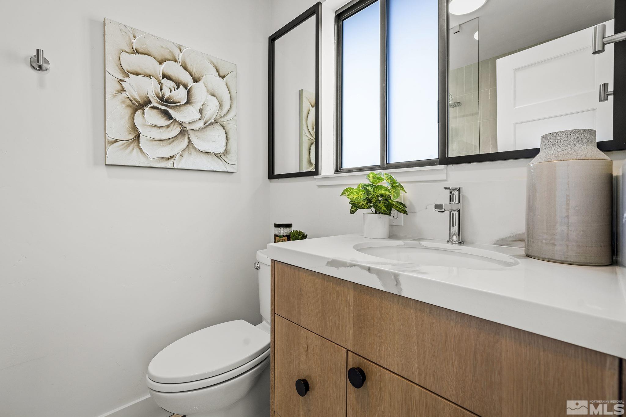 2350 Rodney Drive Reno, NV 89509 - Photo 24 of 40 a bathroom with a granite countertop toilet sink and mirror