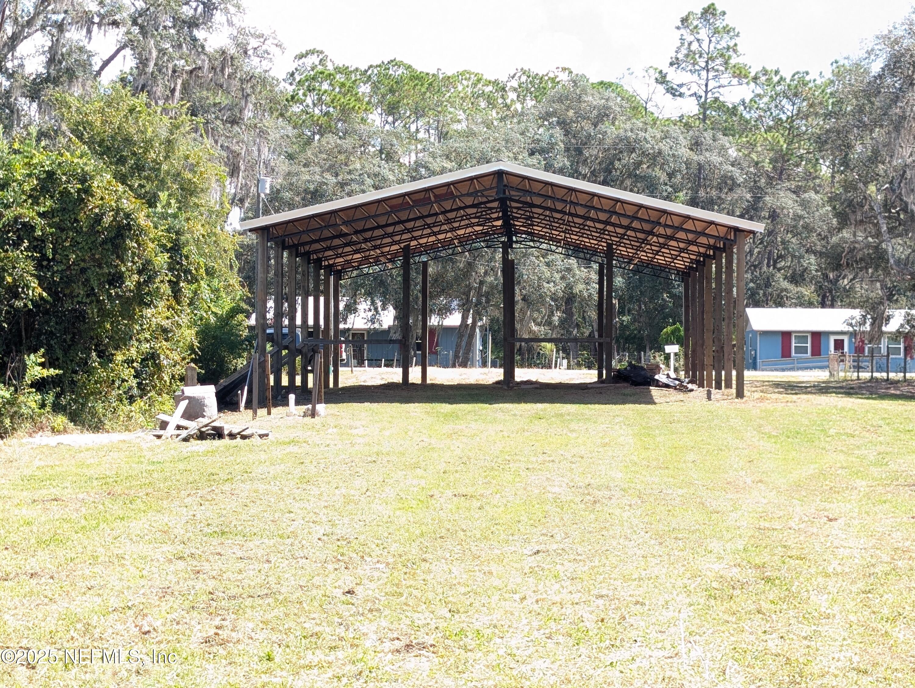 211 Ida Boulevard Interlachen, FL 32148 - Photo 2 of 12 a view of a swimming pool with outdoor seating