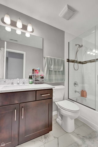 809 Lee Street Des Plaines, IL 60016 - Photo 14 of 18 a bathroom with a sink toilet and shower