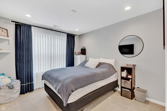 809 Lee Street Des Plaines, IL 60016 - Photo 15 of 18 a bedroom with a bed and a window