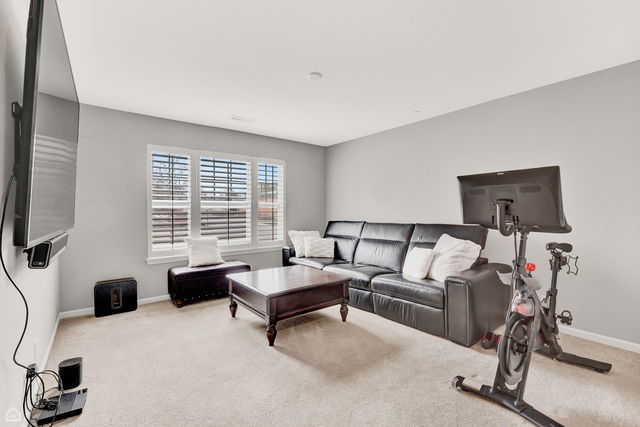 809 Lee Street Des Plaines, IL 60016 - Photo 16 of 18 a living room with furniture and a flat screen tv