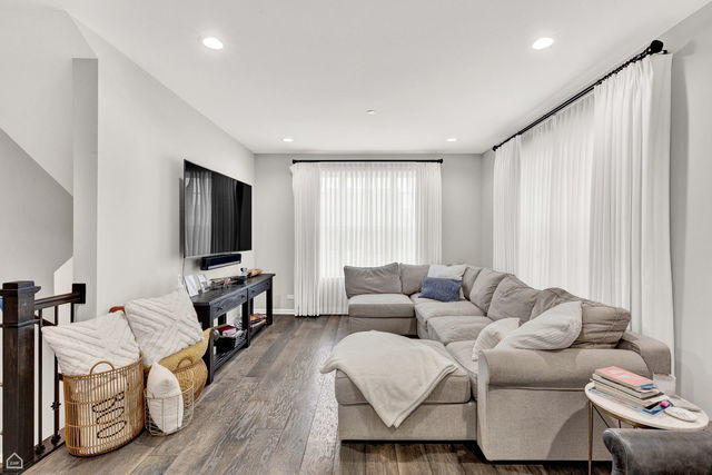 809 Lee Street Des Plaines, IL 60016 - Photo 2 of 18 a living room with furniture and a flat screen tv